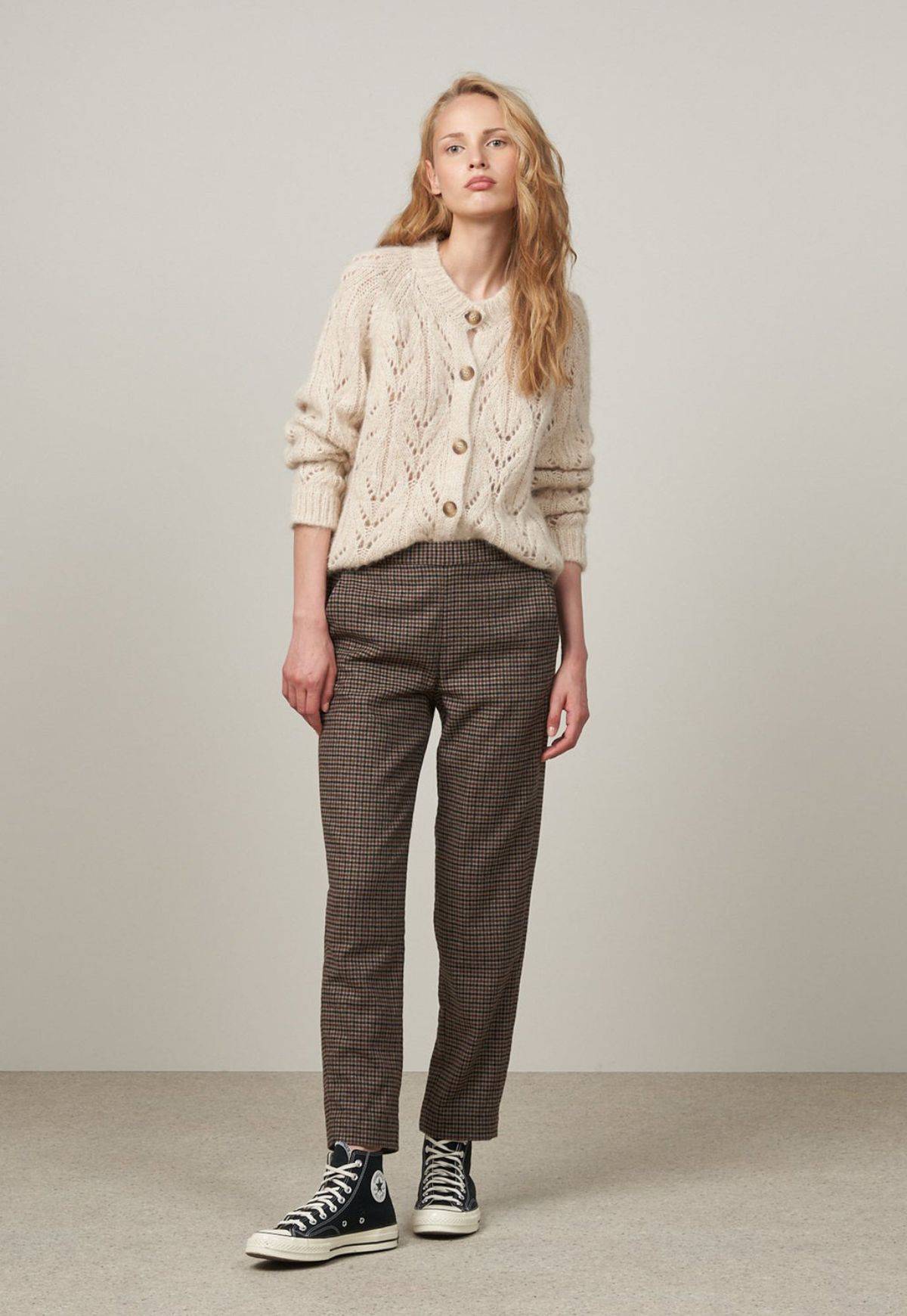 Image of a woman wearing Hartford Pixel Pant. Straight legged, full length trousers in small brown and black check.