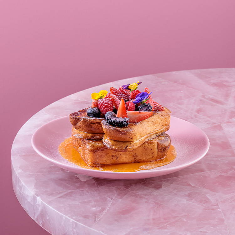 Honey french toast on pink plate
