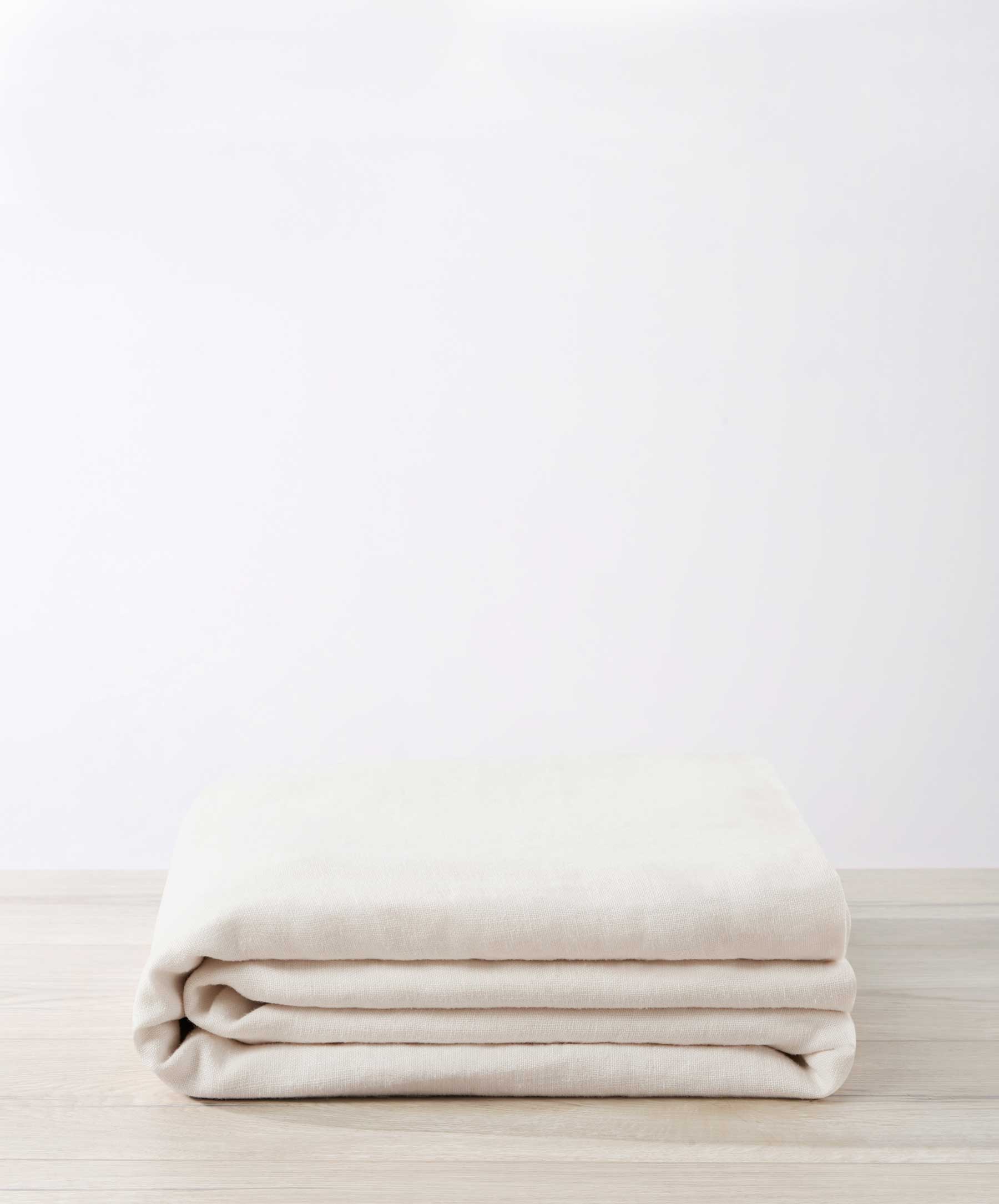 Bedroom Edit - Sky & Ivory folded premium linen bedding showcasing natural texture and sustainable quality The beauty of home