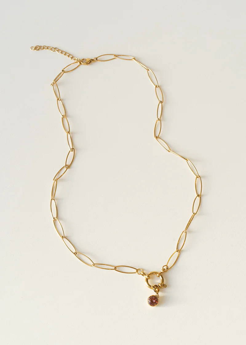 A fine chunky chain necklace with a pale red pendant