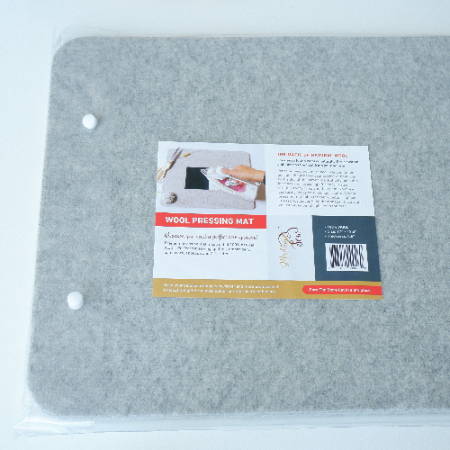 the packaging of a wool pressing mat showing that it is made from 100% wool