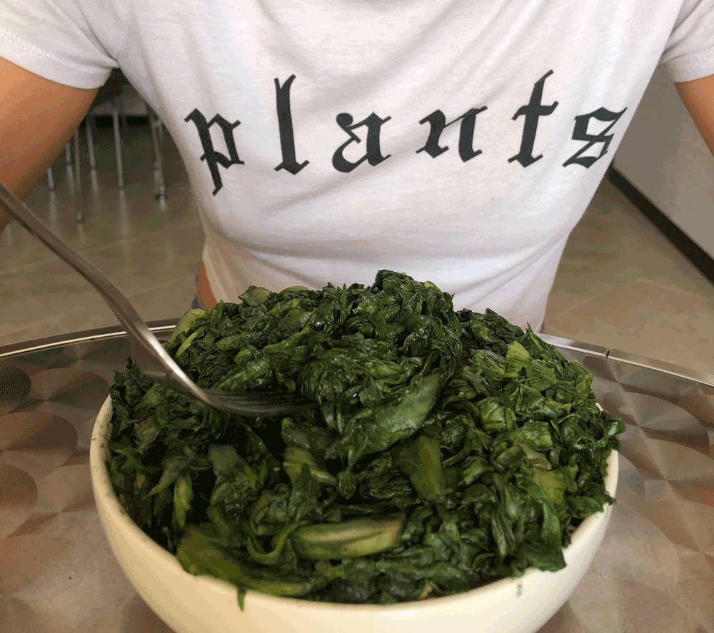 Girl sitting down to eat algae to get her plant-based omega-3s DHA and EPA. 