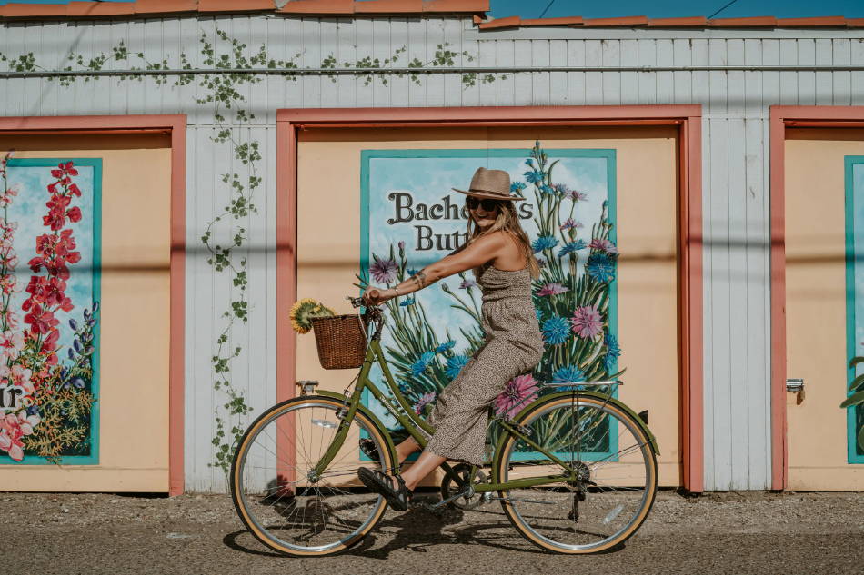 woman wearing sports sandals on a bicycle through town