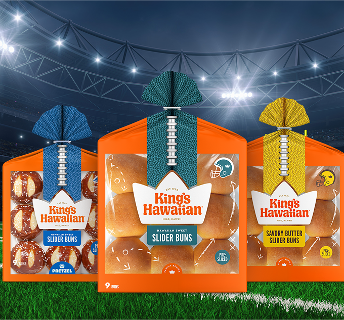 Three packs of King's Hawaiian slider buns on a sports field background.