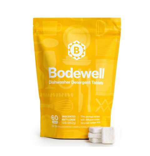 Yellow pouch of Bodewell disinfectant deodorant tablets with two tablets visible.
