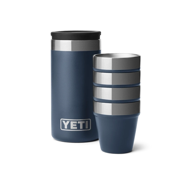 Two navy blue YETI drinkware items, one tall and one short.