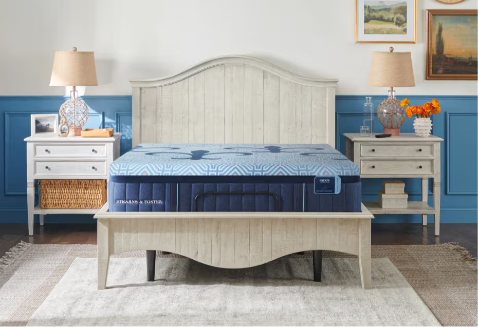 Bedroom with a bed, nightstands, and decorative lamps, promoting mattress collection.