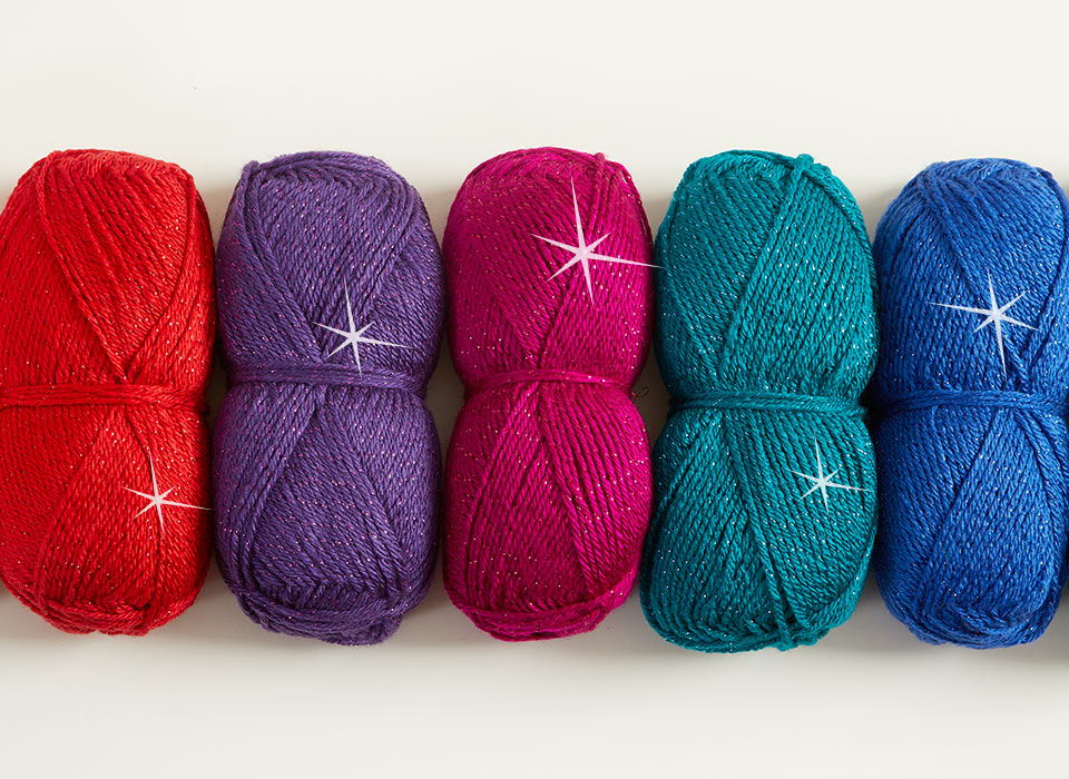 Five sparkling skeins of yarn in red, purple, pink, teal, and blue.