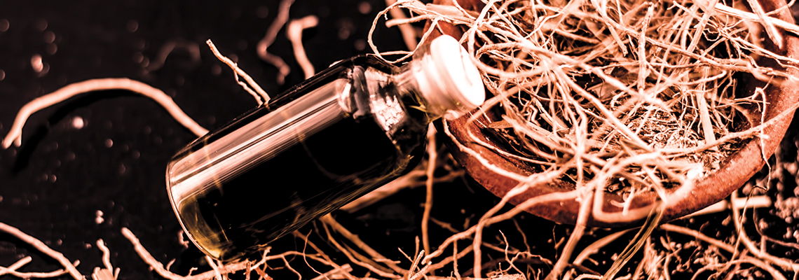 A glass bottle on a bed of straw.