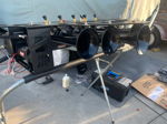 Five black train horns on HB-logo bracket with Viair compressor displayed on stand outdoors