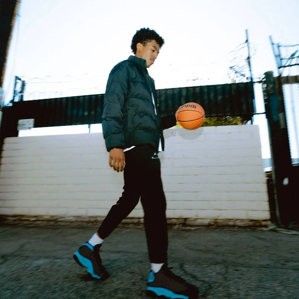 male model wearing aj13 university blue