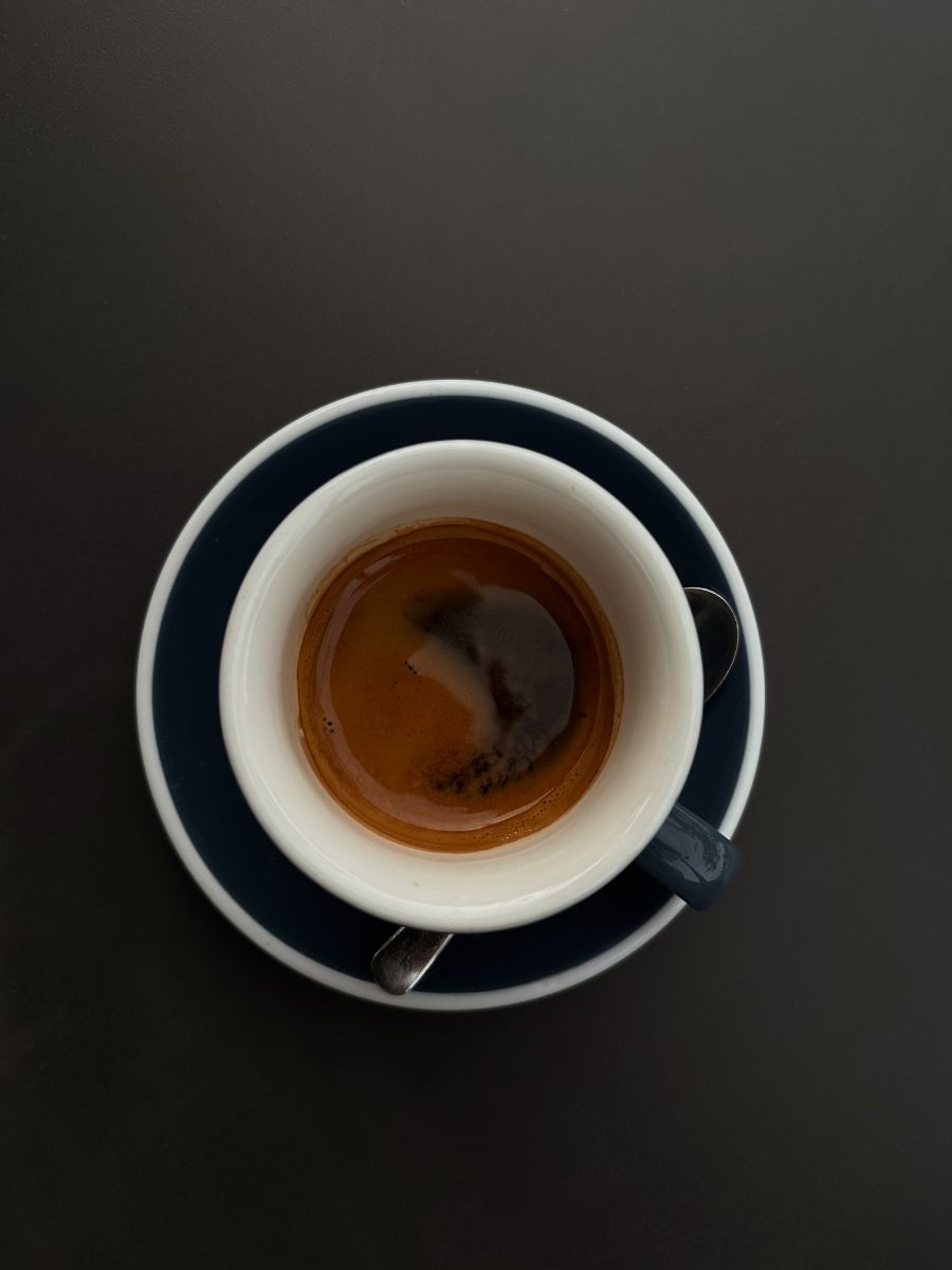 A top view of a cup of coffee on a saucer.