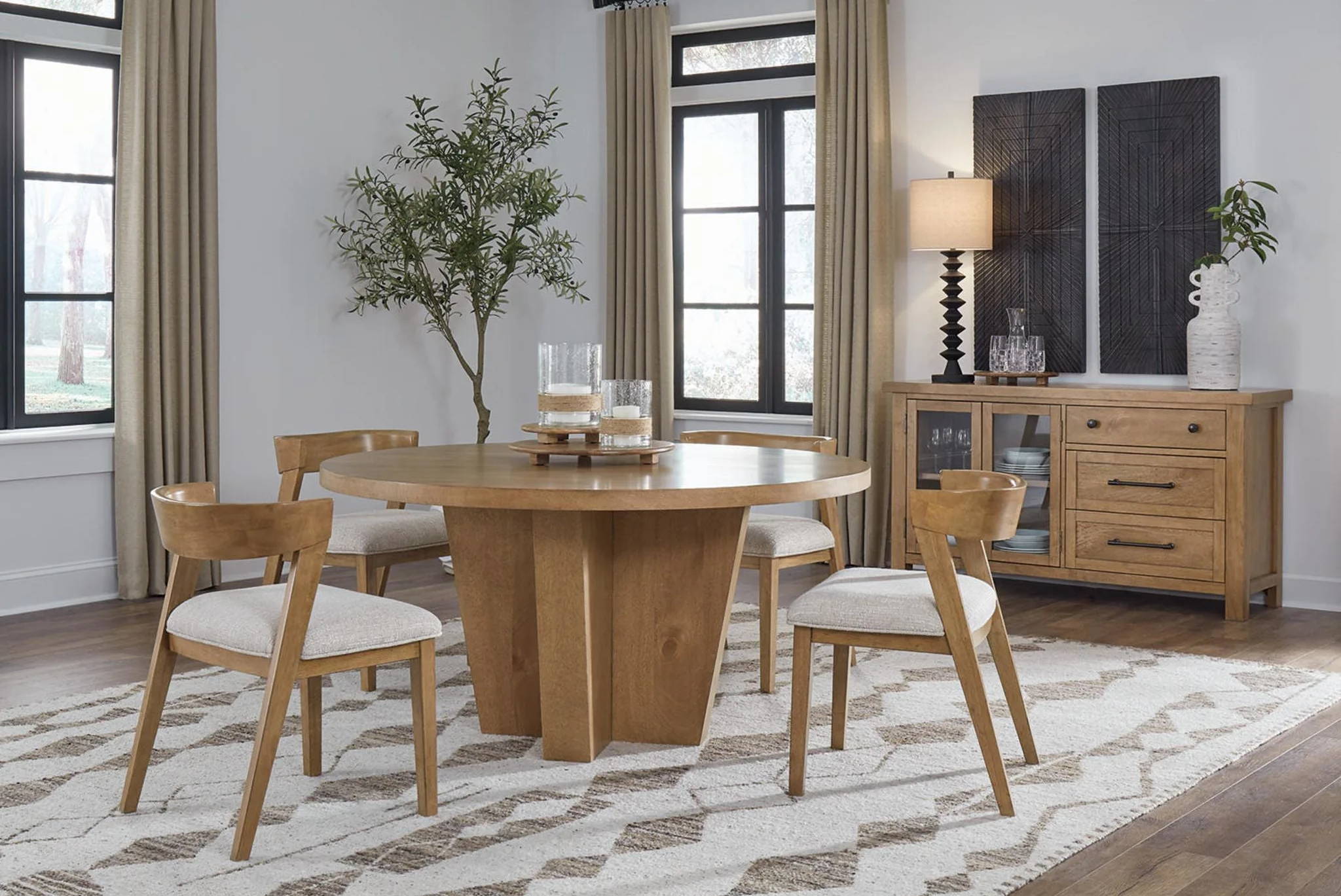Modern dining room with a round table, chairs, and sideboard.