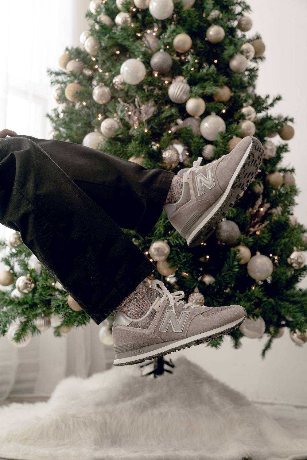 new balance in front of christmas tree