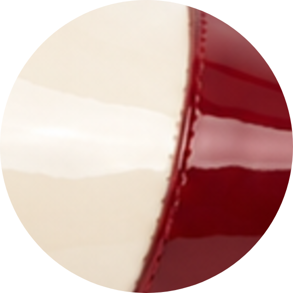 Red and cream colored curved surface with a glossy finish.