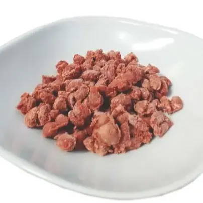 a white dish with raw frozen cat food