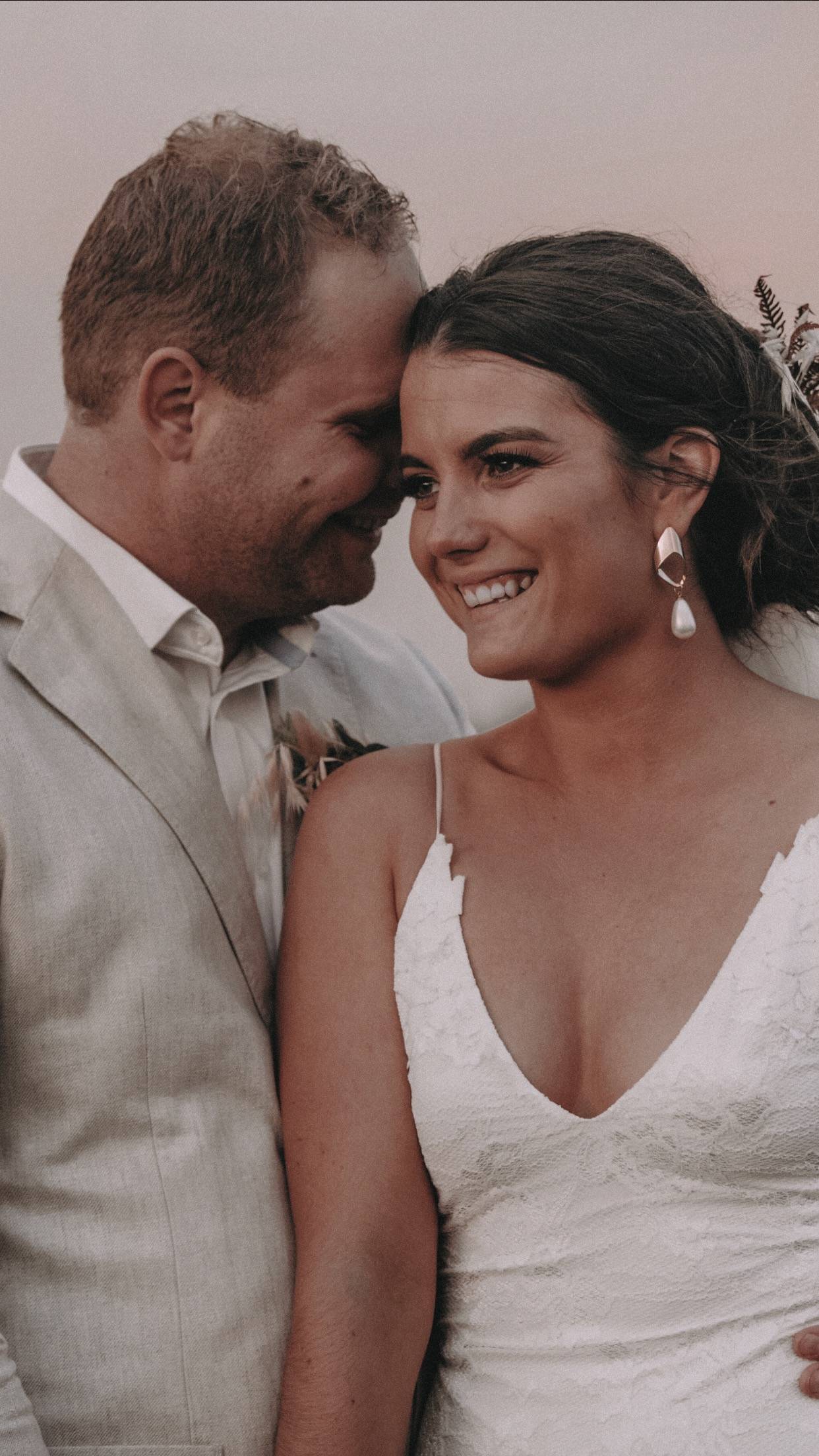 Bride wearing a low scoop lace dress