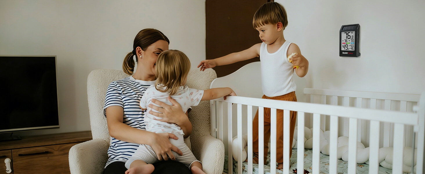 A mother with two young children in a cozy living room setting.