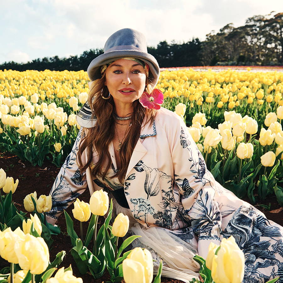 CAMILLA FRANKS OUR FOUNDER & CREATIVE FOUNDER SAT IN FIELDS OF FLOWER