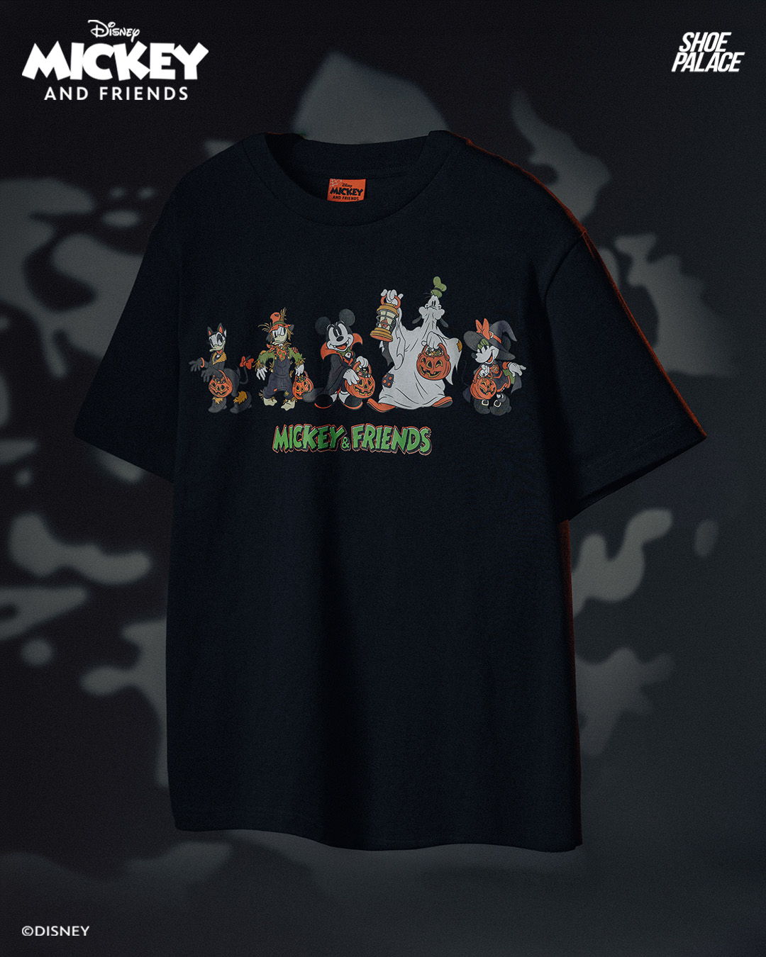 Black t-shirt featuring Disney's Mickey and Friends characters in colorful design.