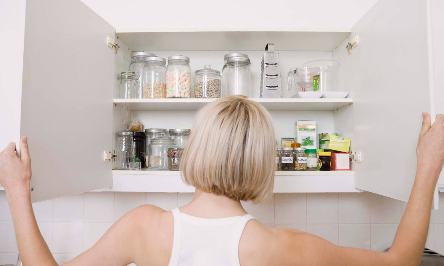 a woman staring into her pantry