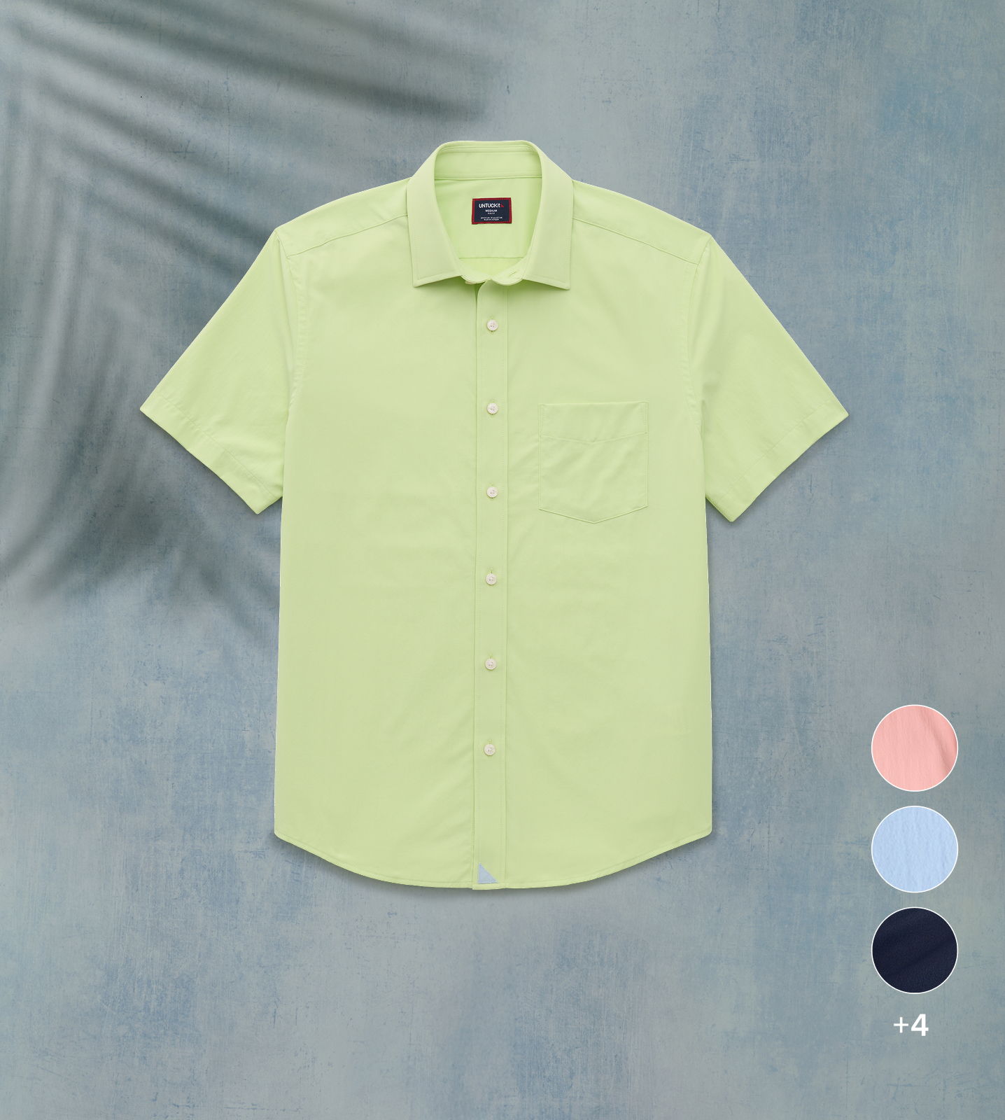 Light green short-sleeve shirt displayed on a textured background with color options.