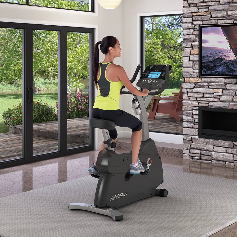 Female exercising at home on C1 Lifecycle exercise bike
