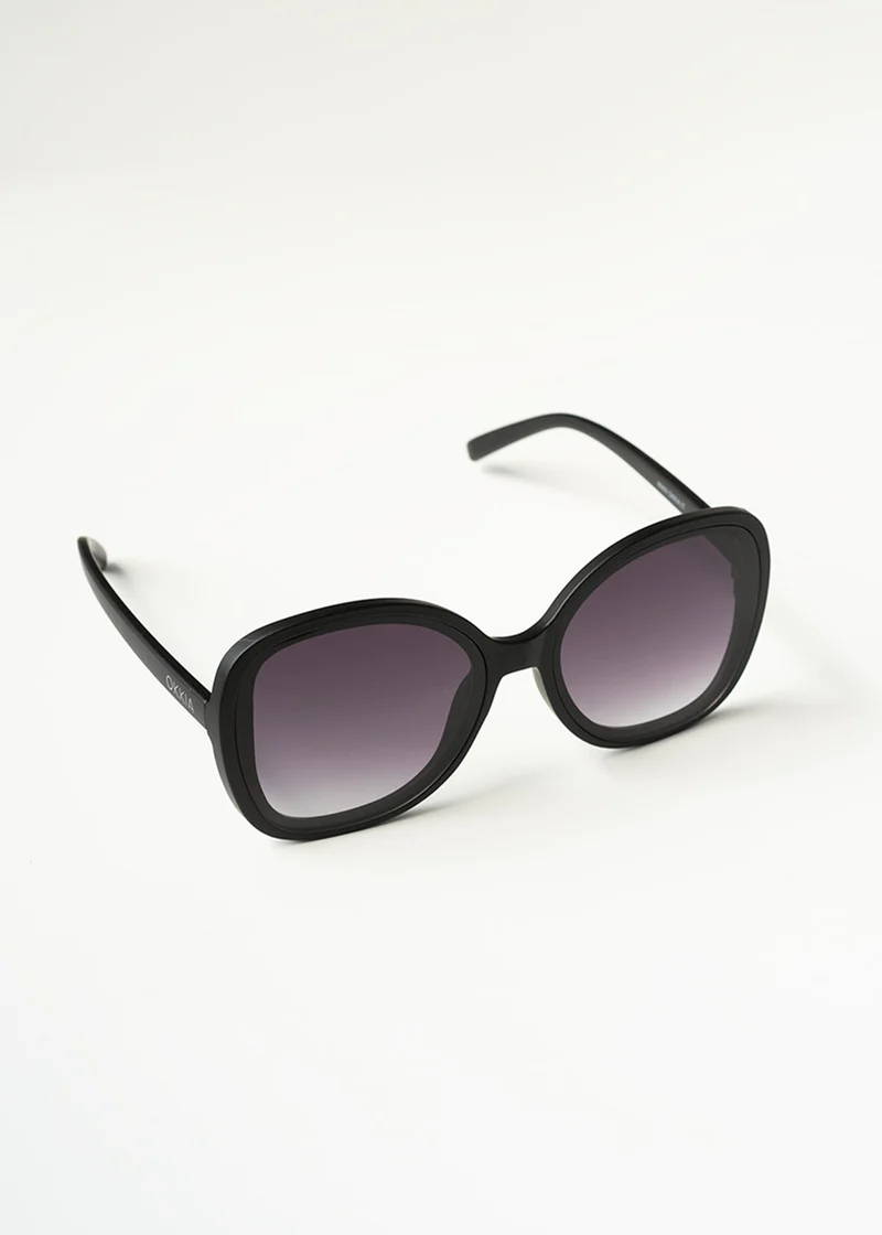 A pair of oval, oversized black sunglasses with tinted lenses