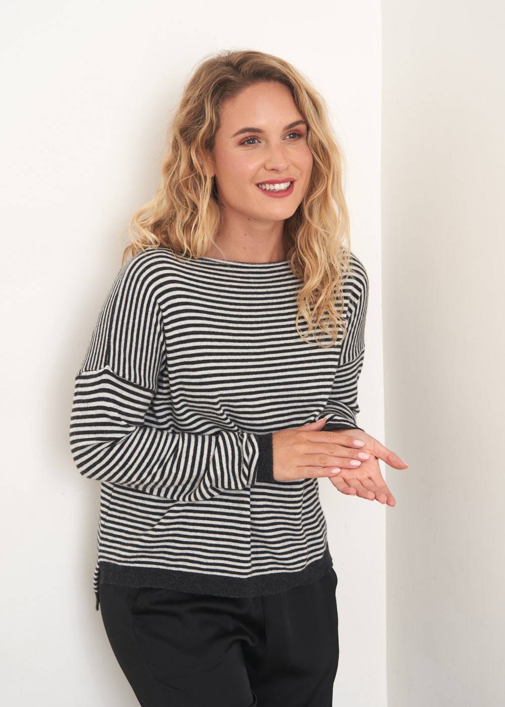 A model wearing a cashmere blend dark grey and off white striped jumper