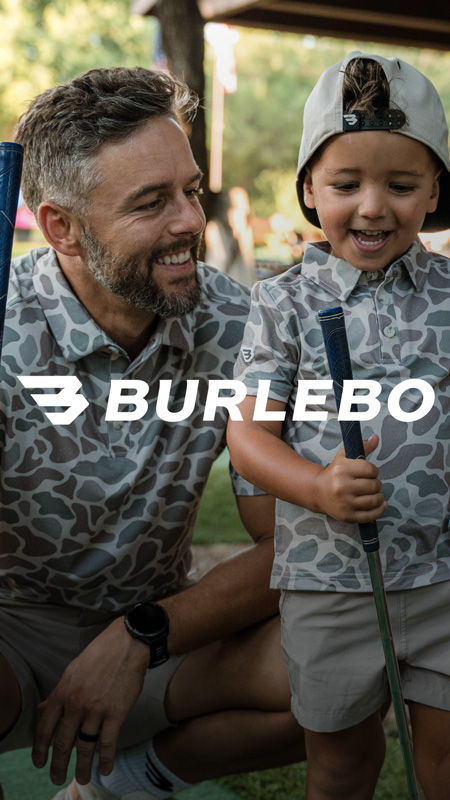 A man and a boy smiling while holding golf clubs.