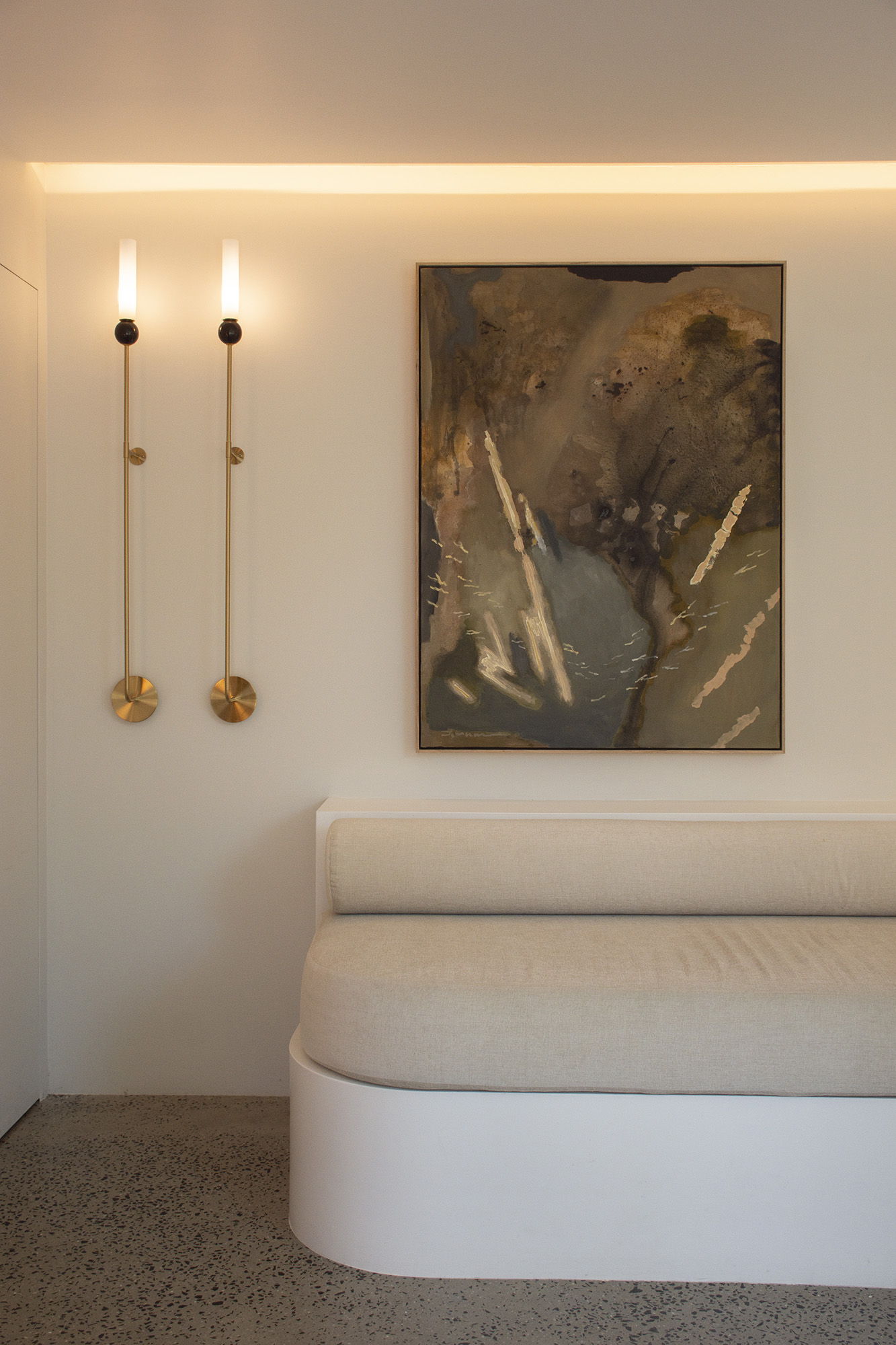 A modern interior with Stephen Skinner's painting 'Liminal' and wall sconces.