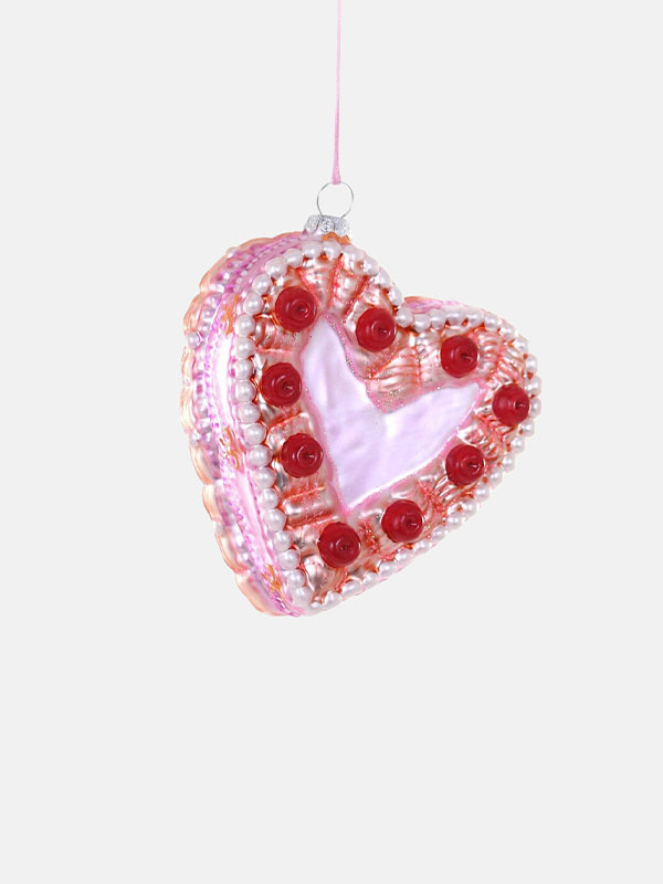 A decorative heart-shaped ornament with pink and red embellishments.