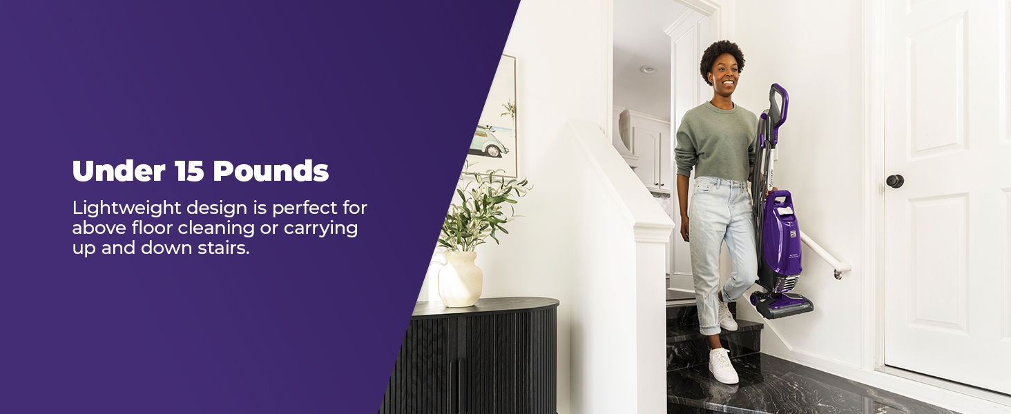 Person using a lightweight vacuum cleaner in a home setting.