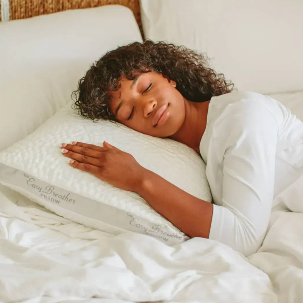 a woman comfortably asleep on an easy breather pillow