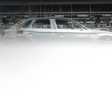 A silver car in an industrial setting.
