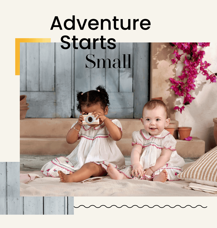 Two babies playing, one with a camera, with the text 