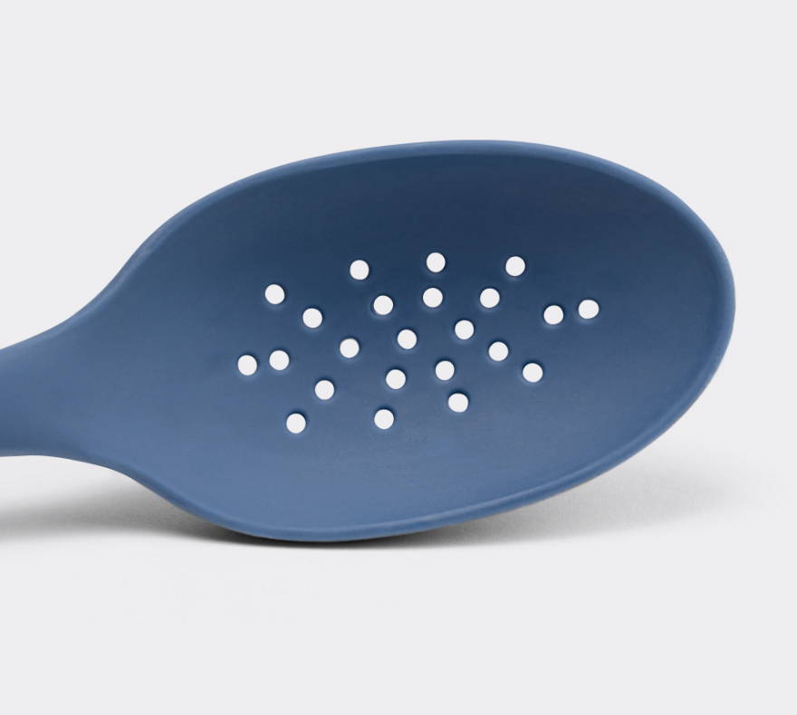 A close view from the front of a Blue Misen Slotted Spoon’s head with drainage holes.