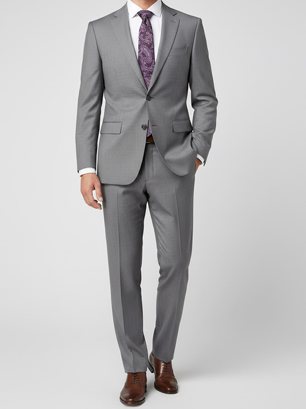 Man wearing a gray suit with a plum paisley tie