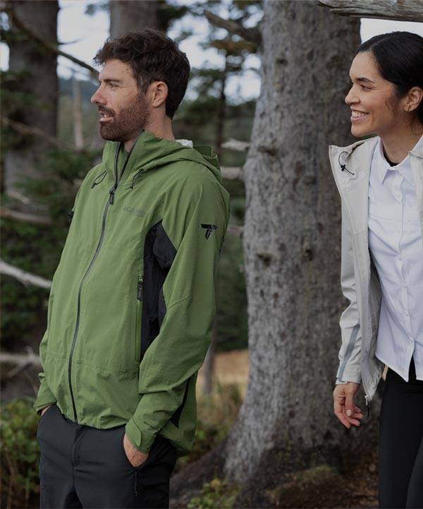 Man & Woman pose for picture while hikng in jackets from Columbia Sportswear