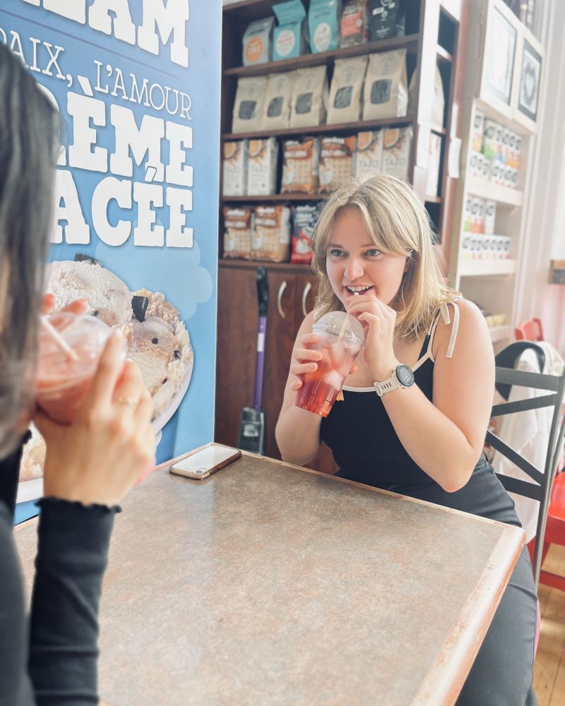 Two people enjoying drinks at a cafe table.