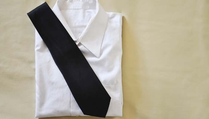 Black necktie on top of white dress shirt