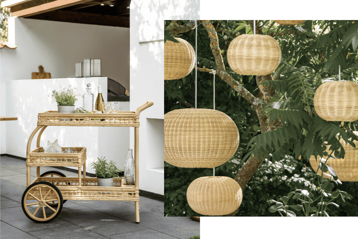 Woven outdoor bar cart and rattan pendant lamps styled on a covered patio surrounded by greenery.