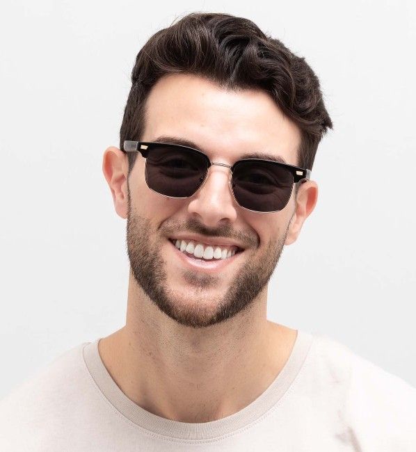 man with oval face wearing Black Jaguar brow-line sunglasses on a white background