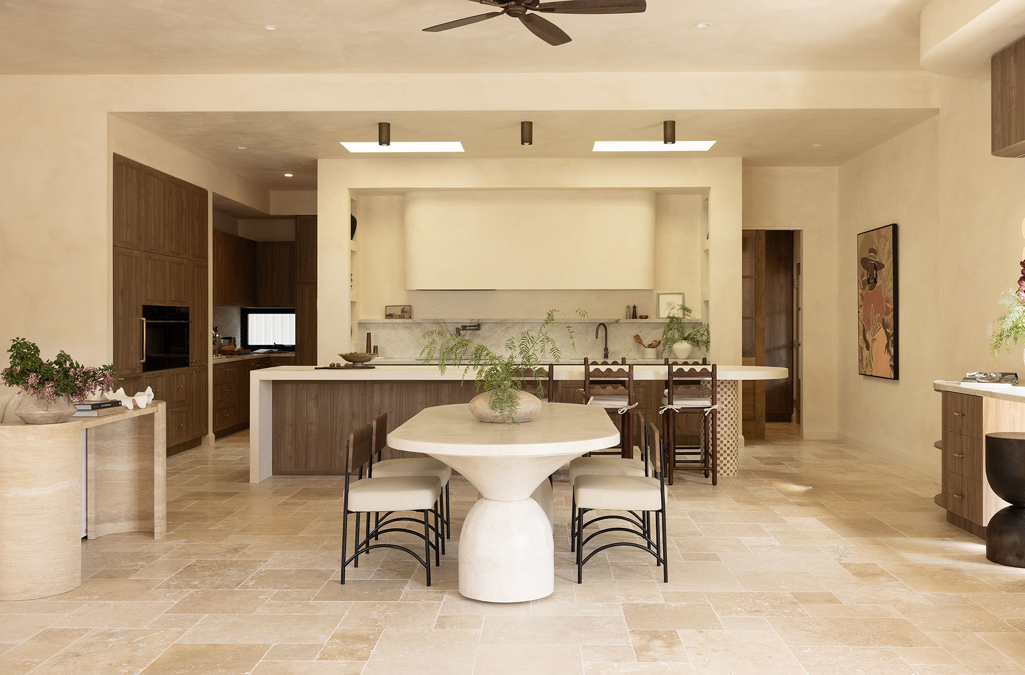 Modern kitchen with dining table, Lighting Collective's Rustic Surface Mounted Downlights, chairs, and neutral decor.