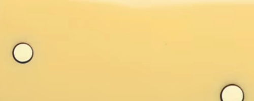 Yellow background with two circular shapes outlined in black.