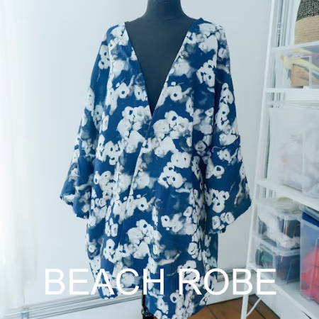 Handmade beach robe kimono style with blue and white flowered fabric on a mannequin