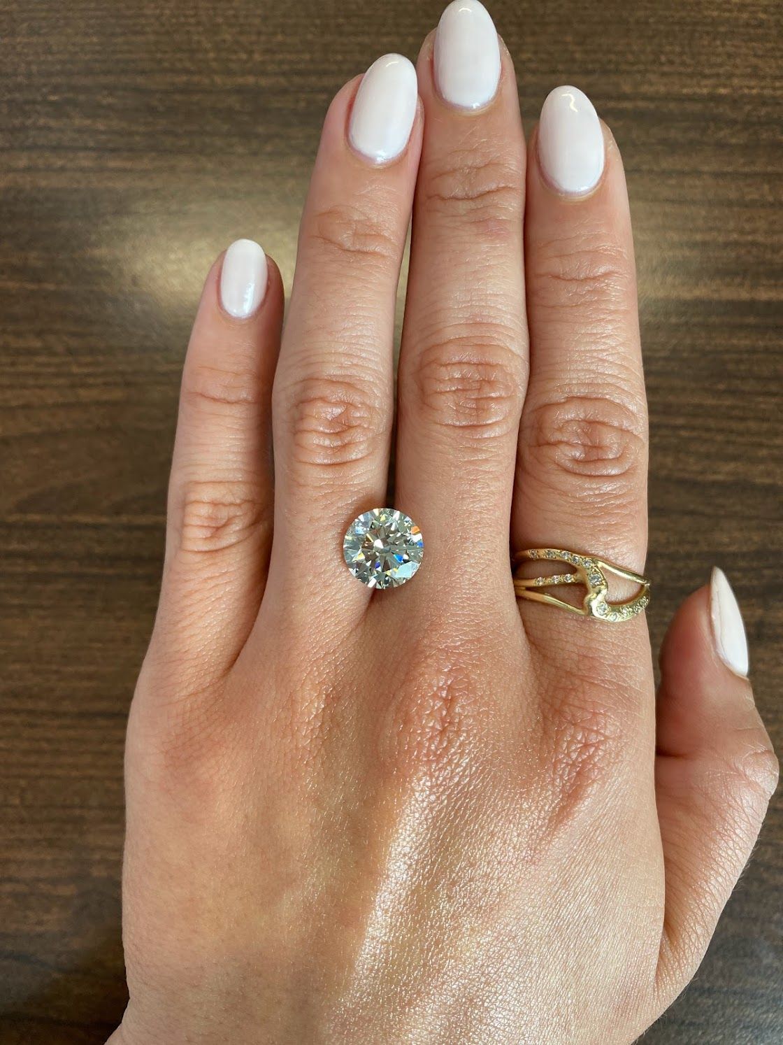 single loose round diamond resting on hand