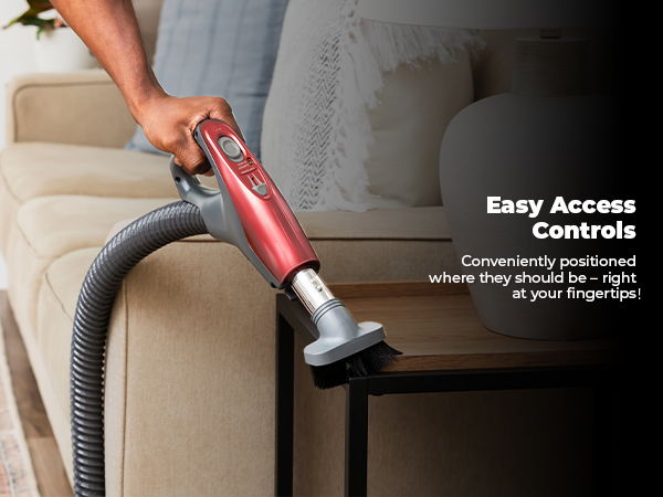 Person using a red vacuum cleaner near a couch with text about controls.