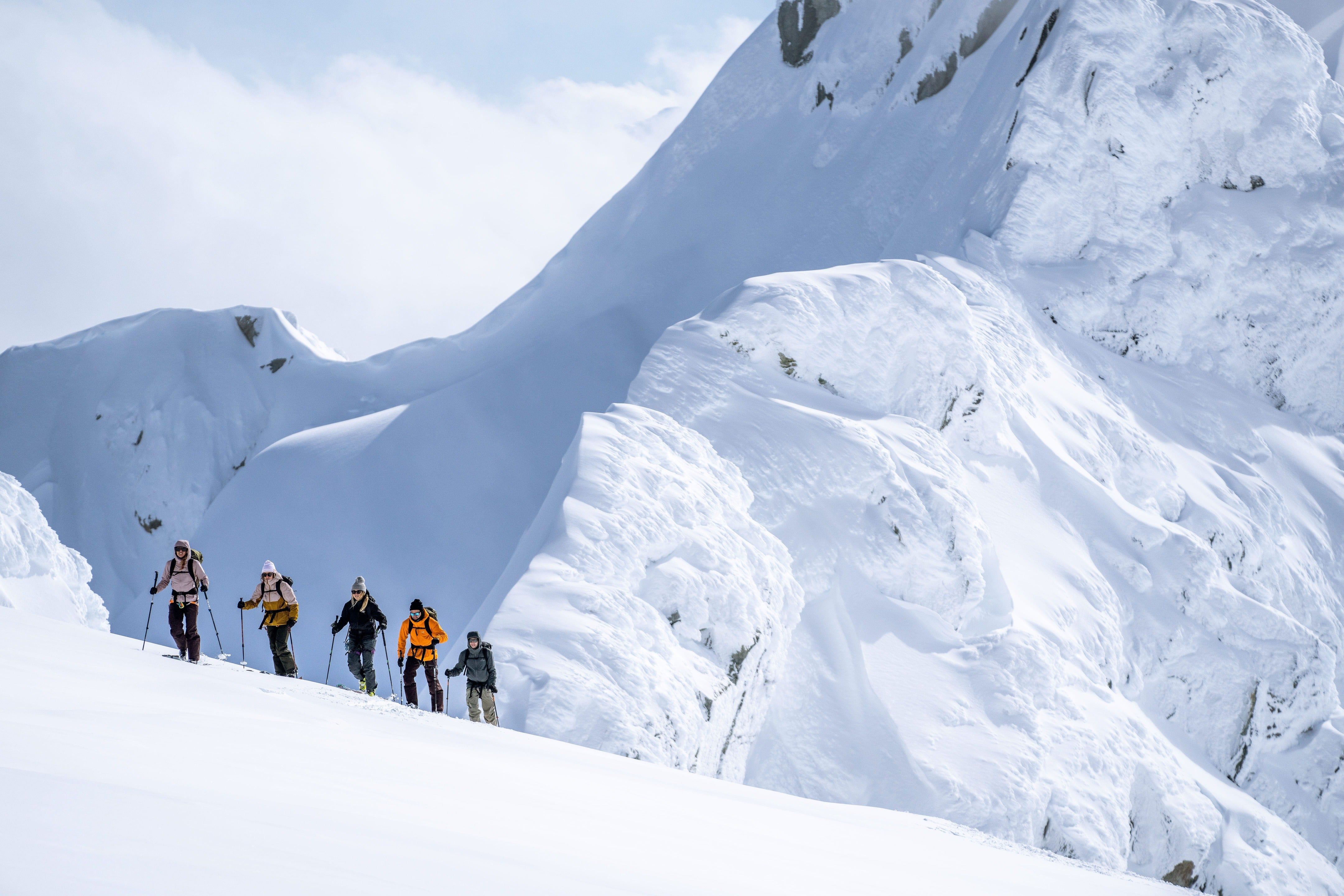 Group of climbers ascending a snowy mountain.