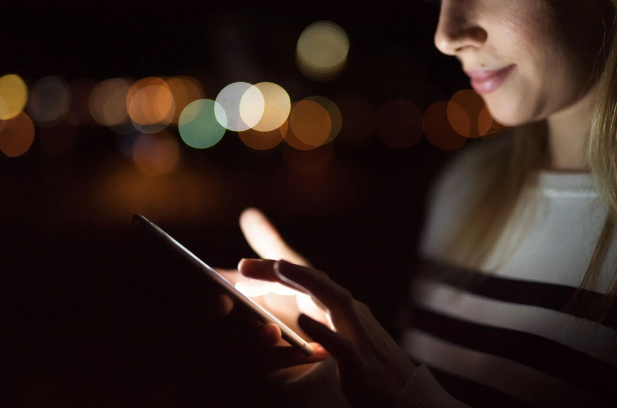 woman scrolling on smartphone